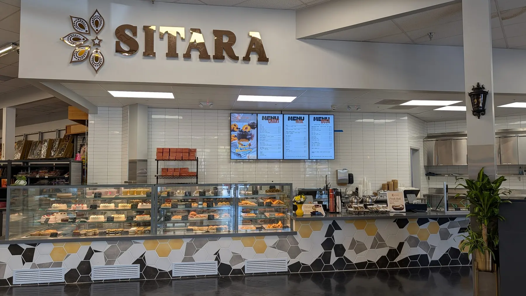 The Sitara café and bakery counter beneath its brass sign