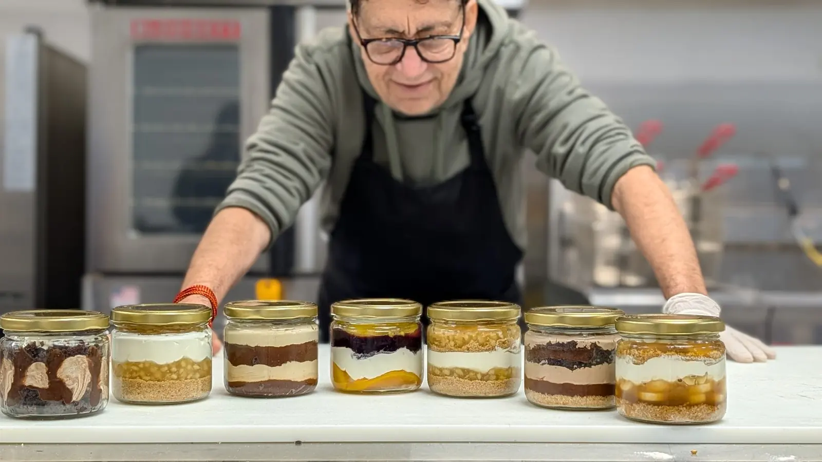 A baker arranging dessert jars inside Sitara